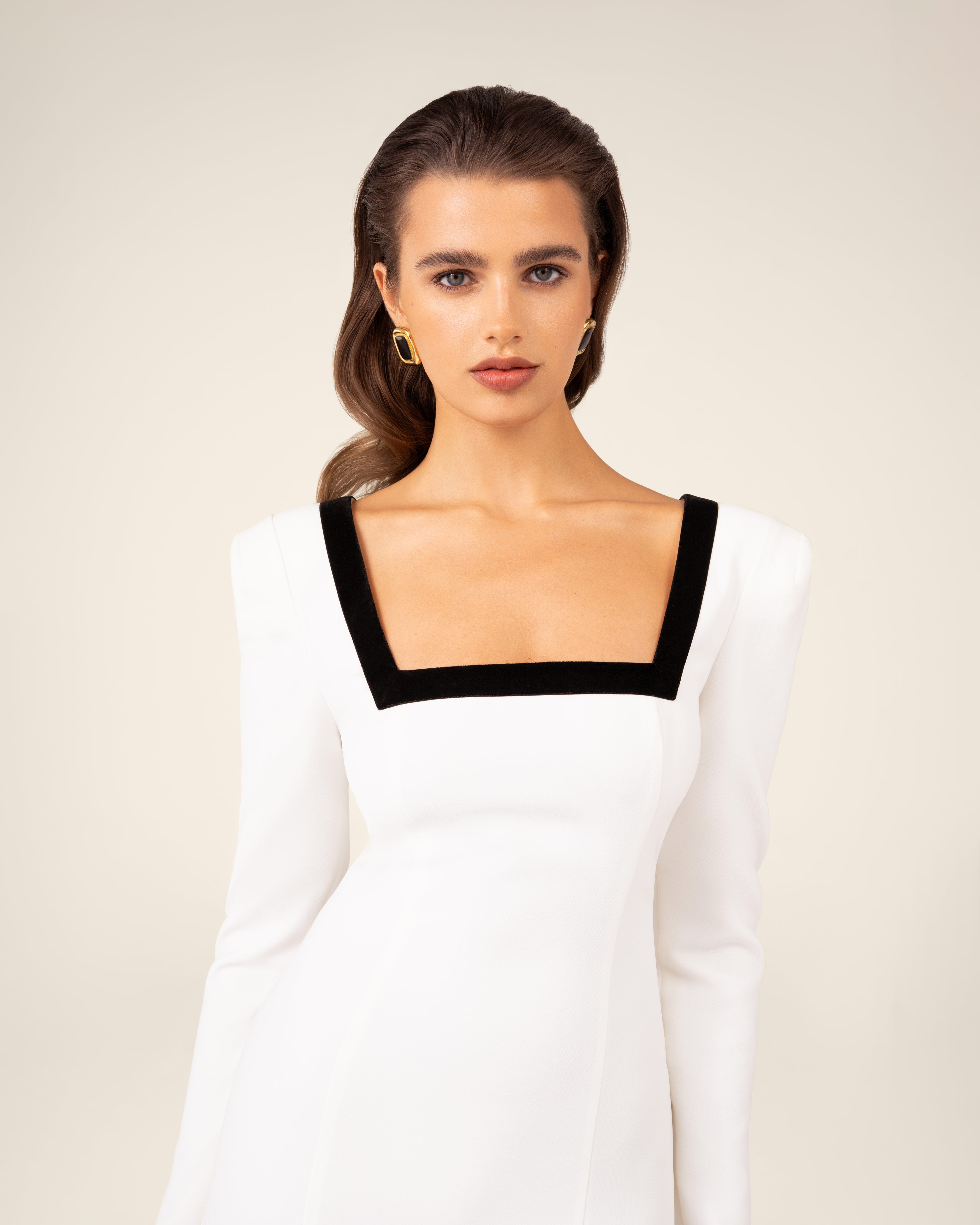 Dress with an asymmetric hem and velvet-trimmed neckline