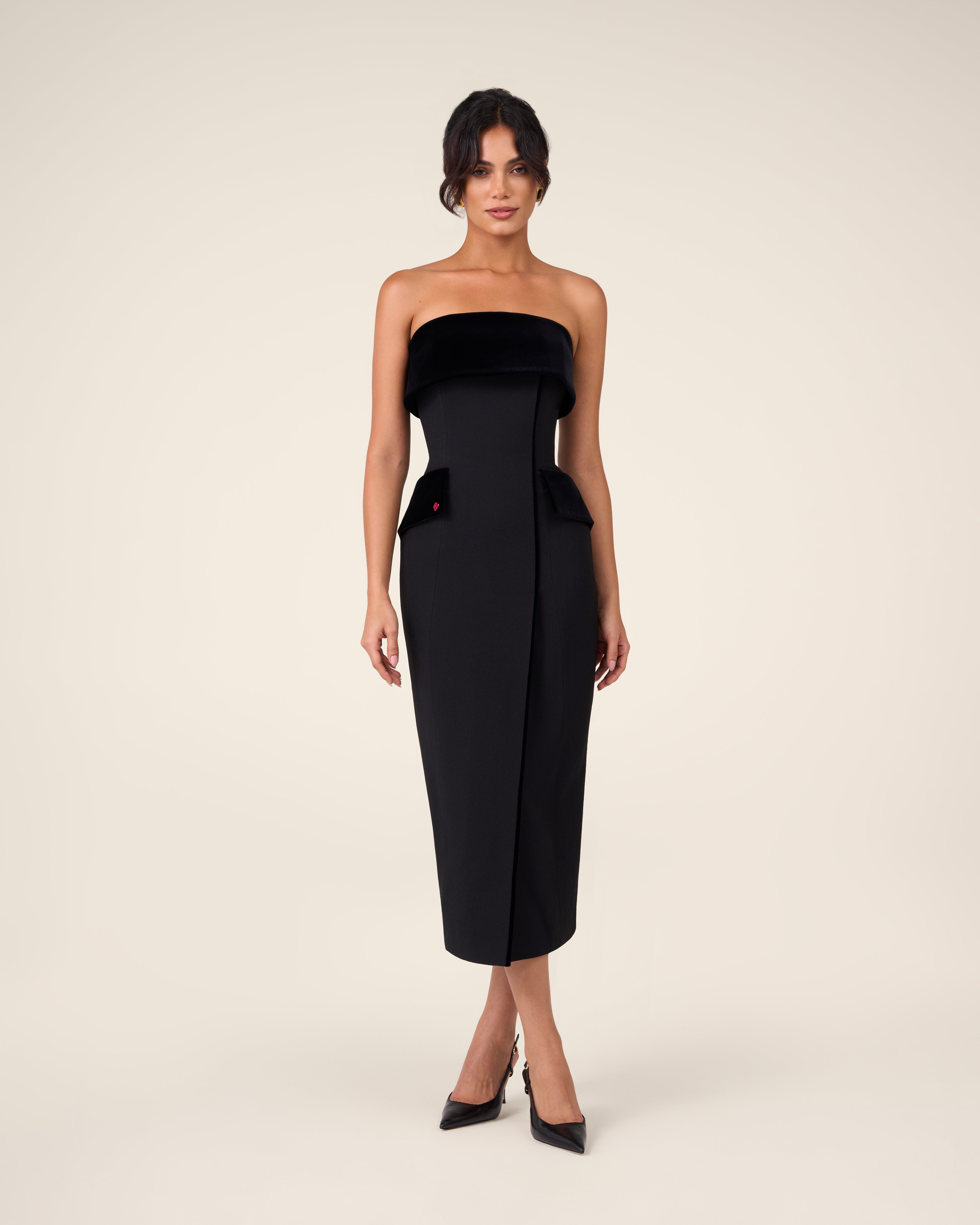Black bustier dress with wide velvet draping across the chest