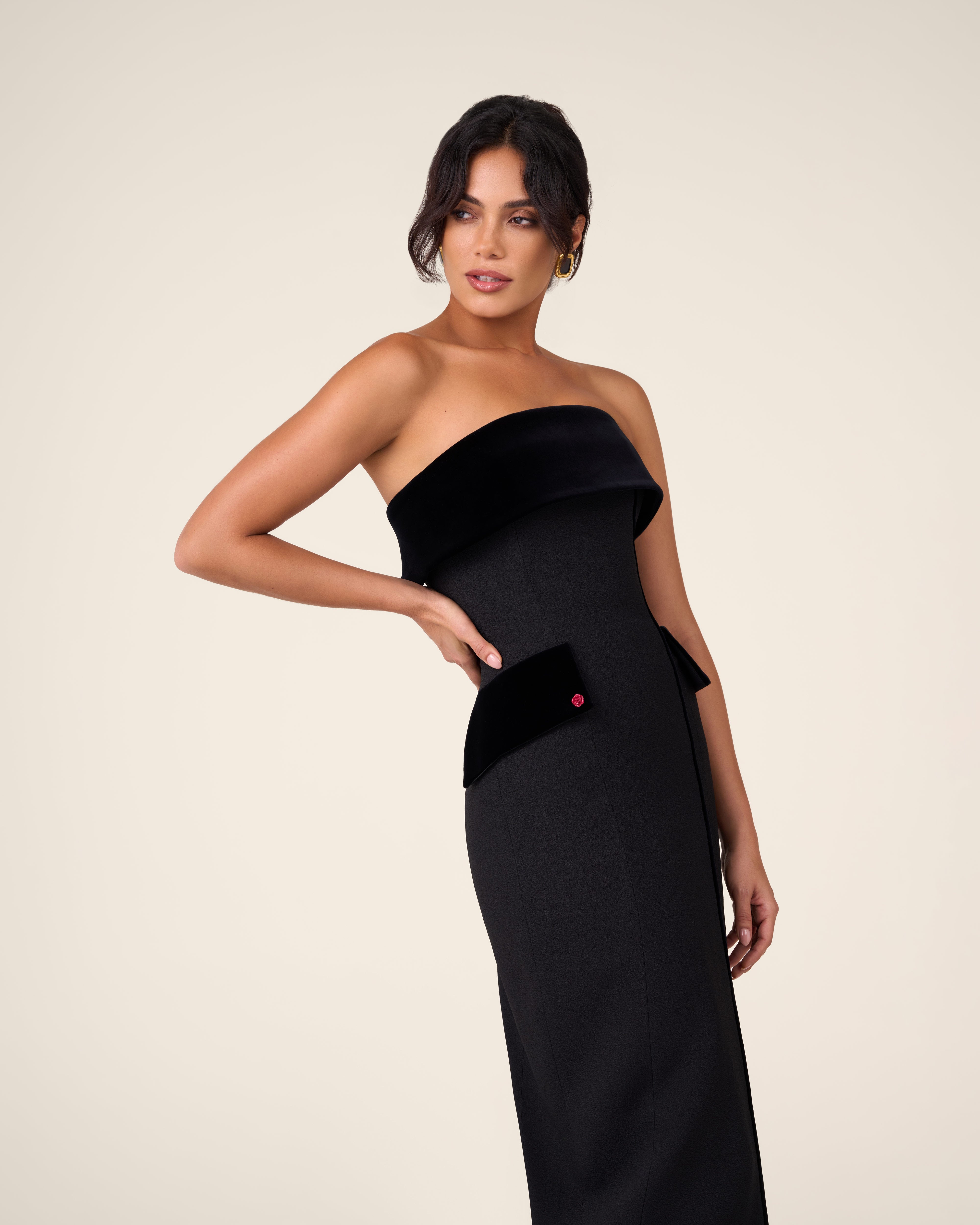 Black bustier dress with wide velvet draping across the chest