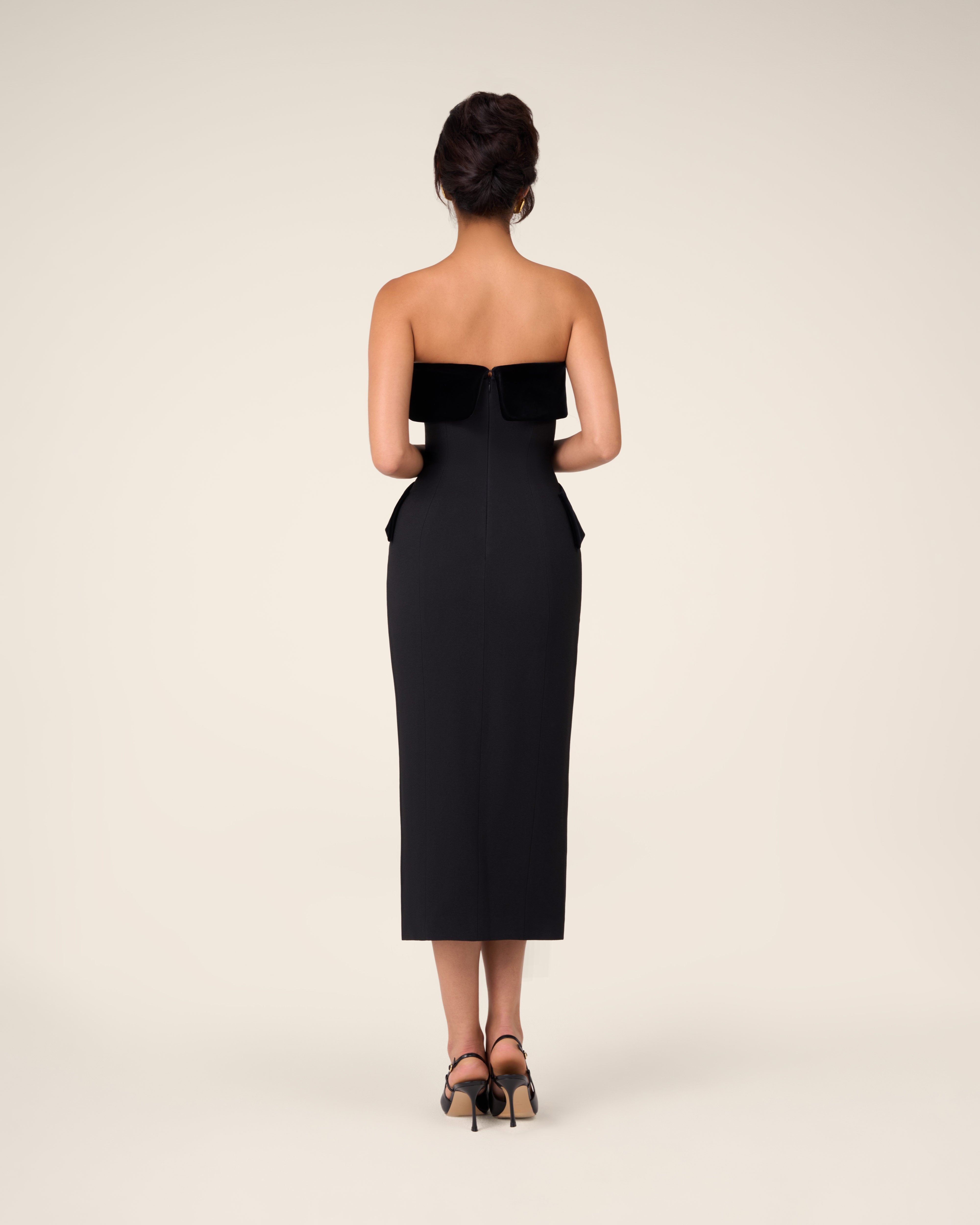 Black bustier dress with wide velvet draping across the chest
